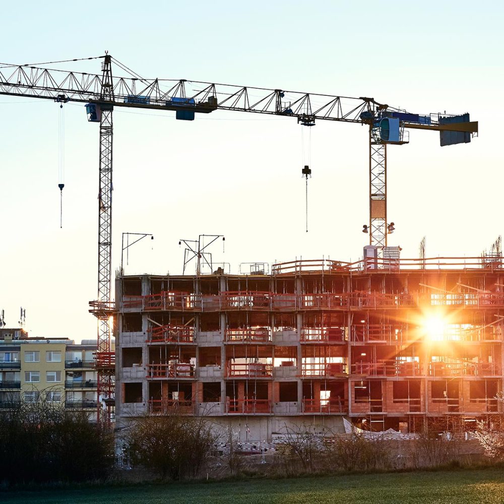 construction-site-with-cranes-at-the-amazing-sunri-SPHELW6